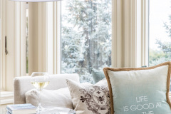 linen slipcover with an organic style on a waterfront property. Perfect spot to read a book and relax.