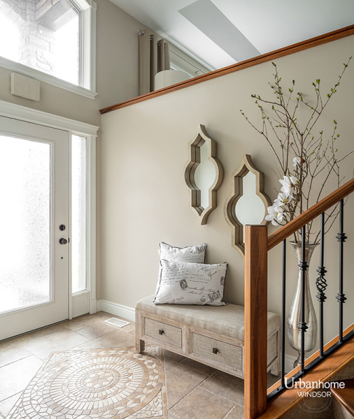 Welcoming entryway with casual elegance, featuring a bench and decorative mirror