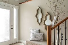 Welcoming entryway with casual elegance, featuring a bench and decorative mirror