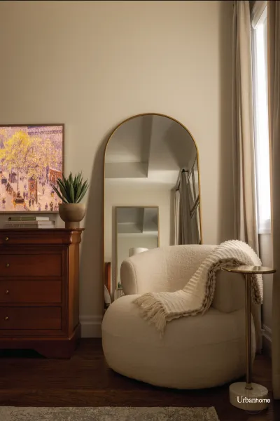 Elegant Bedroom with Gold-Framed Mirror and Accent Chair
