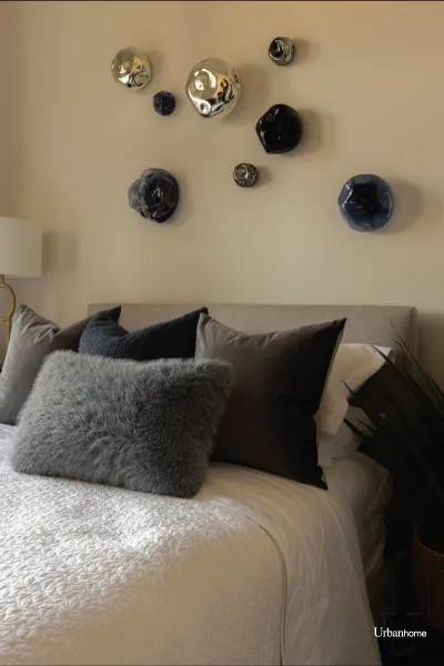 Neutral Bedroom with Cozy Pillow Styling & Artistic Wall Decor