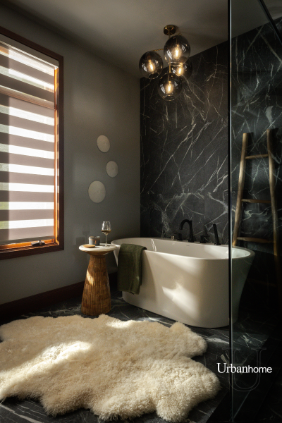 Luxurious bathroom with a deep soaking tub set against a stunning dark marble wall.
