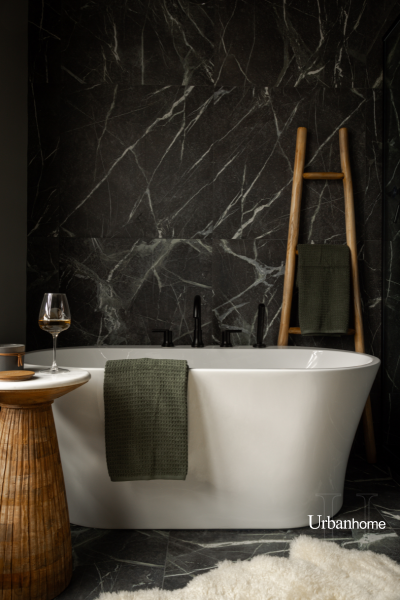 Luxurious bathtub area with dark tile