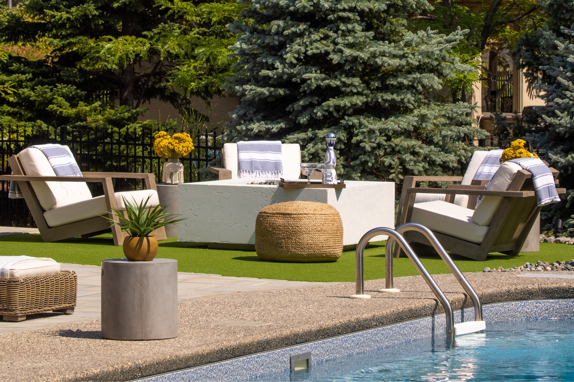 chic modern outdoor sitting area around a concrete firepit on turf