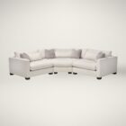 Curved modular sectional sofa in a soft, neutral fabric with tailored lines and multiple accent cushions.