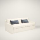 Cream slipcovered sofa with relaxed lines, two blue lumbar pillows, and tailored arms, shown in a styled neutral-toned living room and product view.