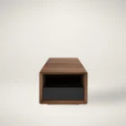 Rectangular walnut coffee table with a recessed black base drawer, open shelving, and clean modern lines, shown in studio and styled living room settings.