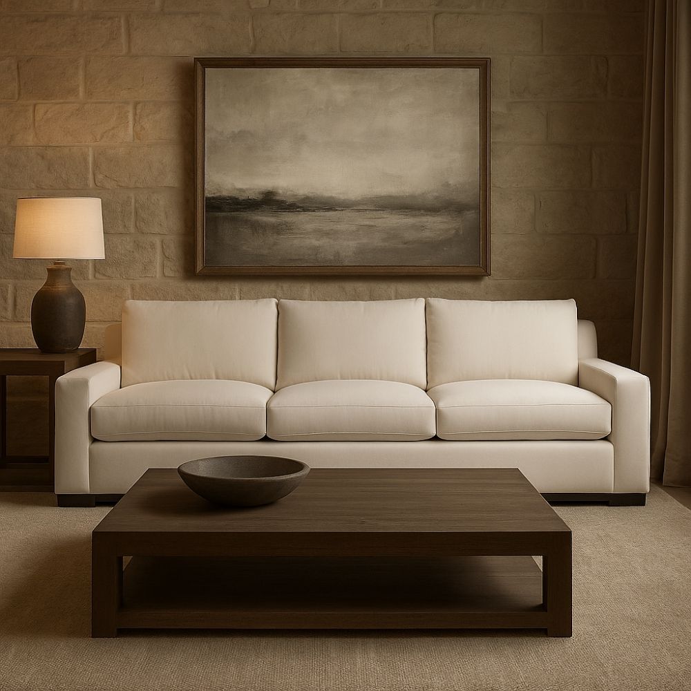 Contemporary low-profile sofa in soft white fabric with boxy arms and plush cushions, shown in product and styled living room views.