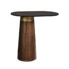 Oval black stone-topped side table with a flared wood base and brass detailing, styled next to a modern sofa in a sunlit living room.