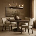 The Aniston Dining Chair featuring a sculpted mid-back silhouette, textured neutral upholstery, and tapered wood legs for a refined yet relaxed look.