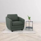 Modern club chair with plush cushions, curved arms, and dark wooden legs.