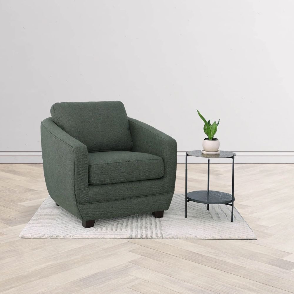 Modern club chair with plush cushions, curved arms, and dark wooden legs.