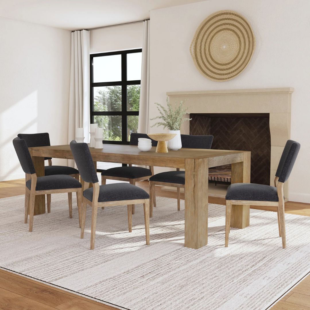 A rustic modern rectangular dining table made of natural wood with thick, block-style legs and a clean-lined silhouette.