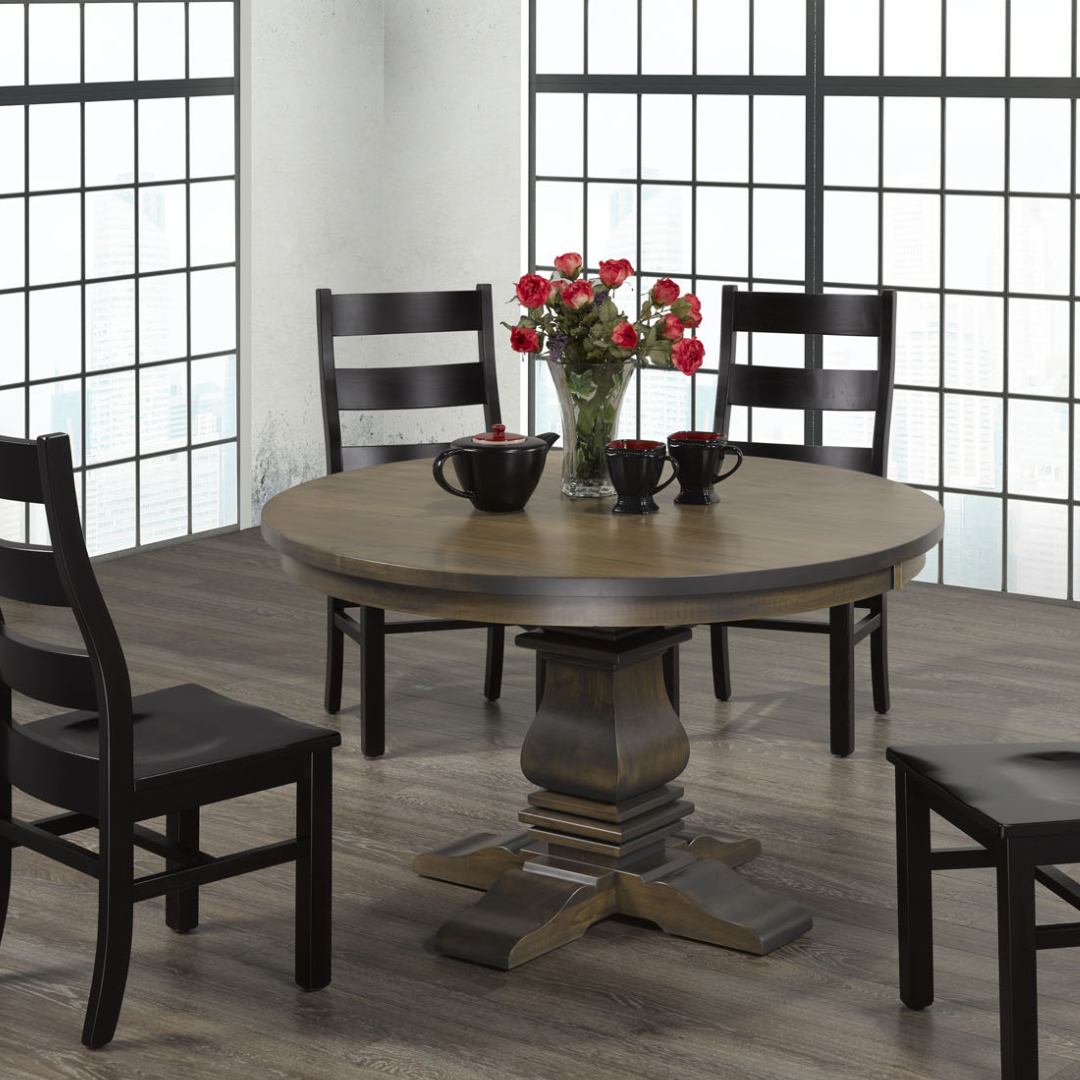 Traditional round dining table in a rich wood tone with a sculpted pedestal base and cross-shaped feet.
