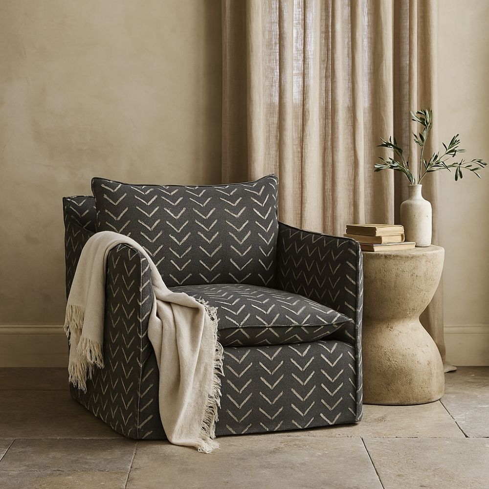 Modern black swivel glider chair with bold chevron upholstery pattern and plush cushion.
