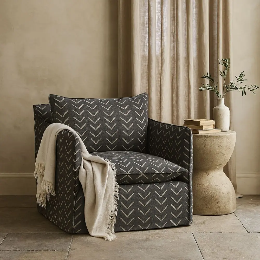 Modern black swivel glider chair with bold chevron upholstery pattern and plush cushion.