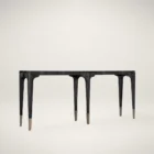 Long black wood console table with sculpted legs and metallic foot caps, finished in a Shou Sugi Ban burnished texture