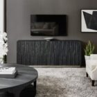 Charred black entertainment console with vertically stacked wood texture and subtle metallic base, inspired by the Shou Sugi Ban technique.
