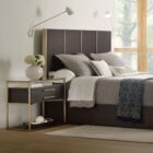Modern wood and metal nightstand with glass top and two drawers.