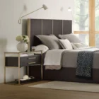 Modern wood and metal nightstand with glass top and two drawers.