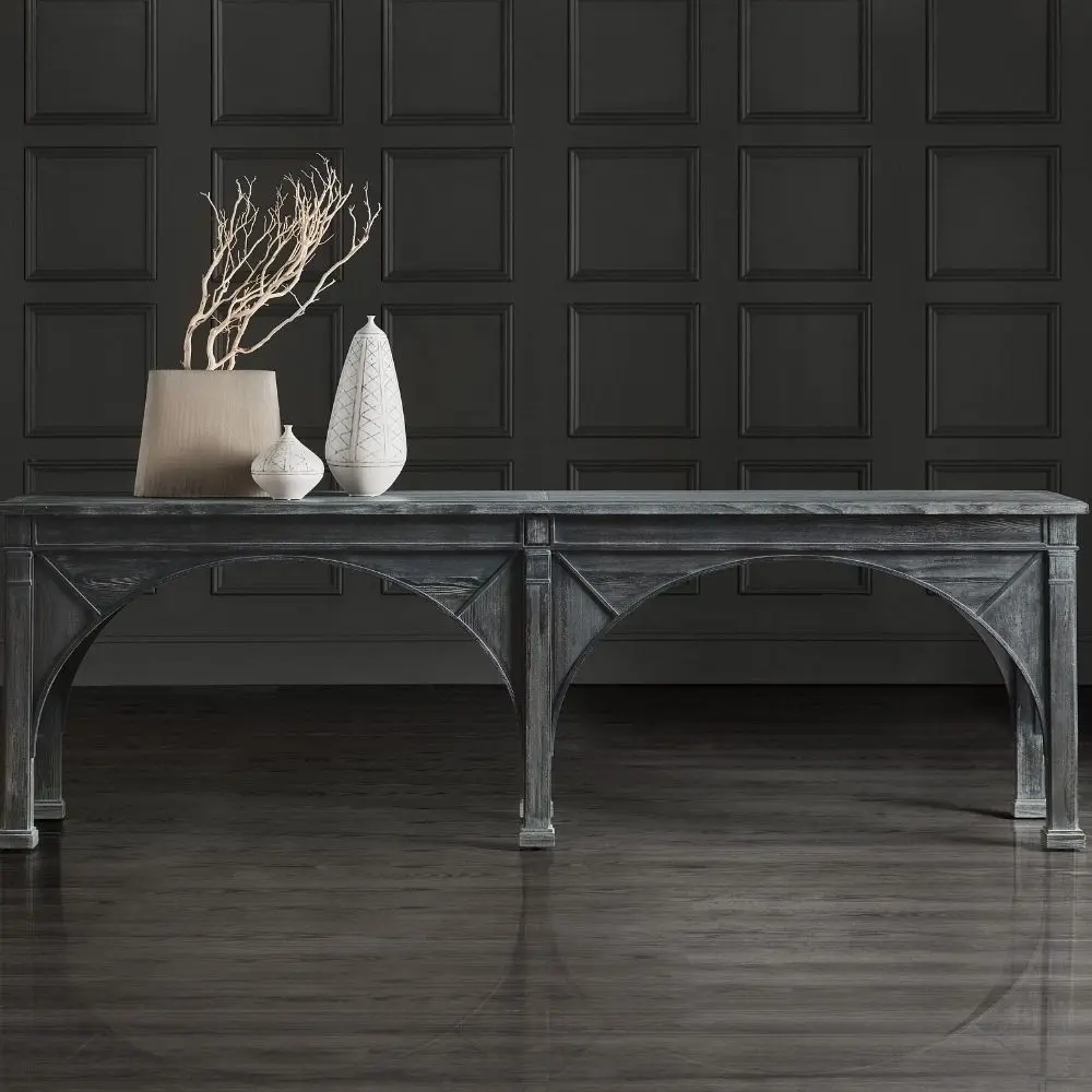 Long black console table with cathedral-inspired arch detailing and a distressed wood finish.