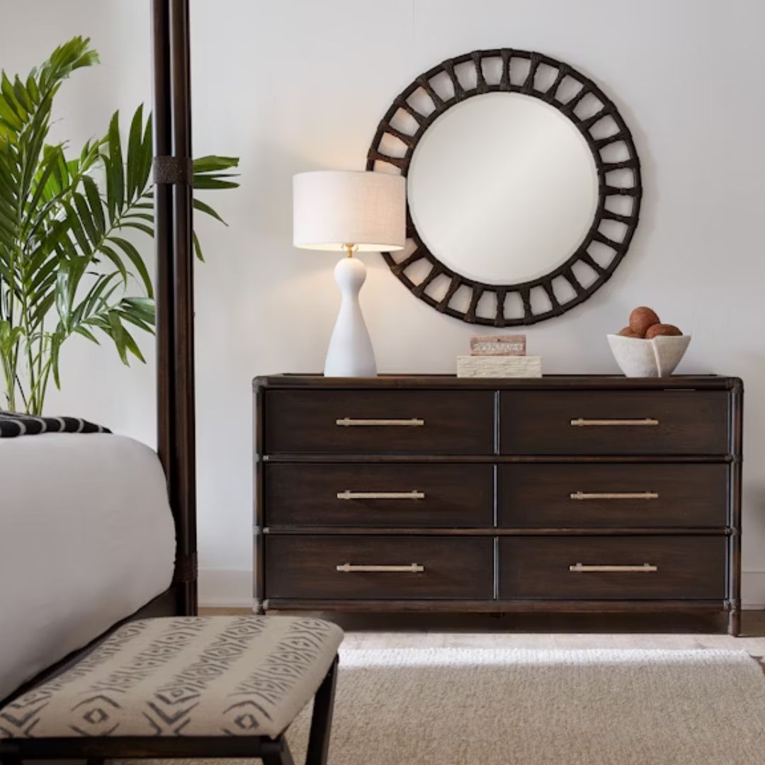 Dark wood six-drawer dresser with brass hardware and rounded frame details.