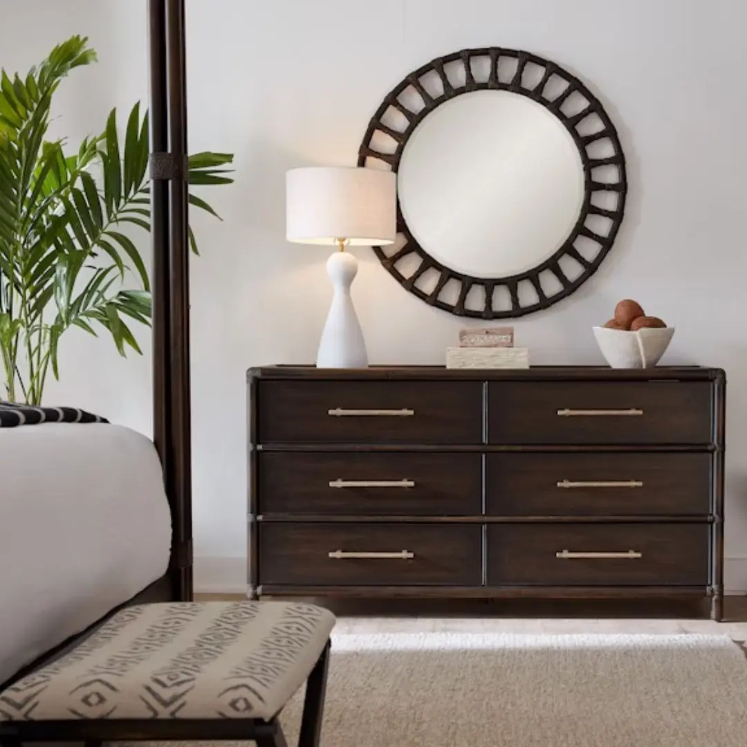 Dark wood six-drawer dresser with brass hardware and rounded frame details.