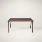 Minimalist walnut office desk with slim tapered legs and modern design.