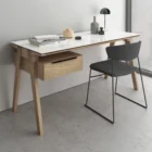 Minimalist birch wood desk with cream top and integrated drawer unit on the left side.