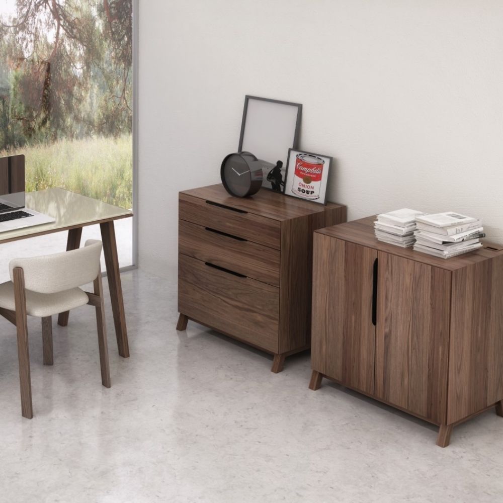 Three-drawer walnut wood cabinet with minimalist silhouette and integrated pulls.