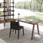 Minimalist walnut office desk with slim tapered legs and modern design.