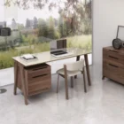 Modern walnut and cream office desk with slim legs and integrated storage drawers