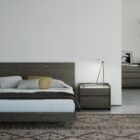 Modern two-drawer nightstand with marble top and dark wood finish.