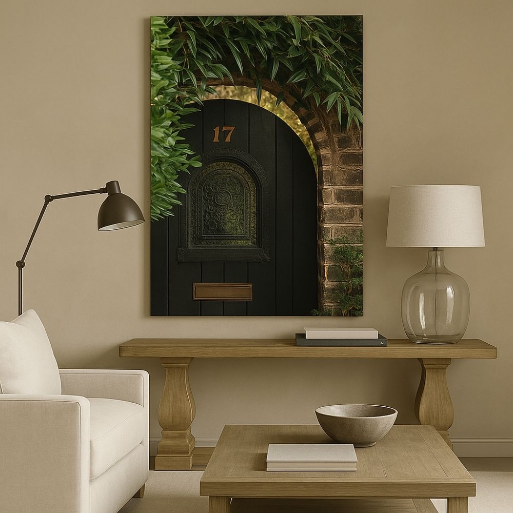 Photograph of a rustic black arched door with the number 17, framed by ivy and aged brick.