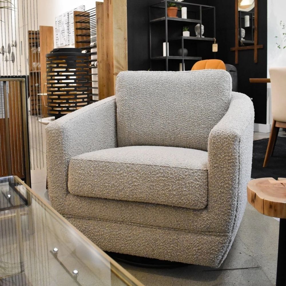 Modern white club chair with plush cushions, curved arms, and dark wooden legs.