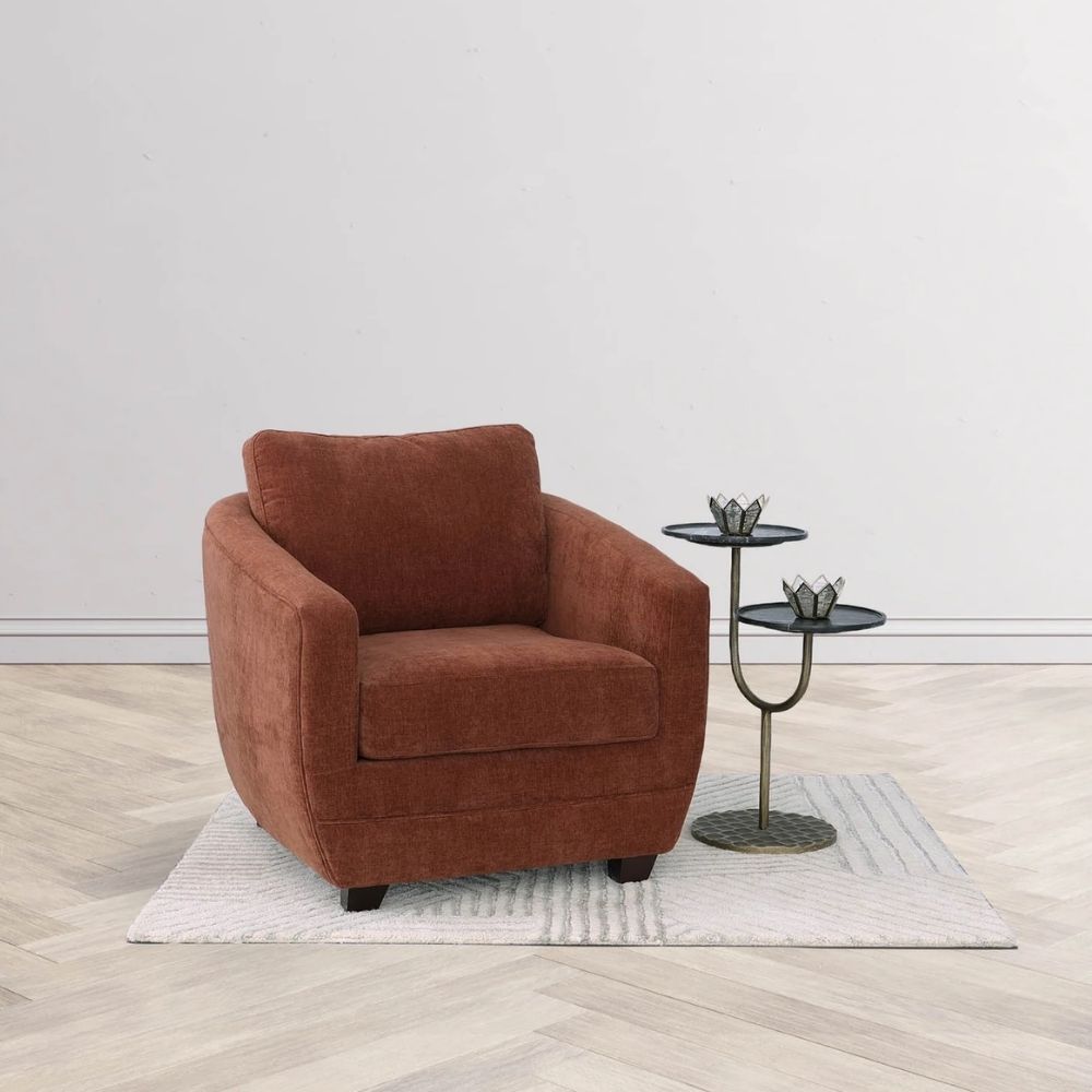 Modern club chair with plush cushions, curved arms, and dark wooden legs.