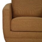 Modern club chair with plush cushions, curved arms, and dark wooden legs.