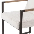 The LH Imports Breve Dining Chair features a softly curved upholstered seat in a neutral tone, supported by warm wood legs with a mid-century silhouette.