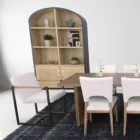 The LH Imports Breve Dining Chair features a softly curved upholstered seat in a neutral tone, supported by warm wood legs with a mid-century silhouette.