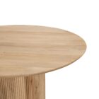 Round natural wood dining table with a fluted cylindrical pedestal base and smooth tabletop.