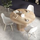 Round natural wood dining table with a fluted cylindrical pedestal base and smooth tabletop.