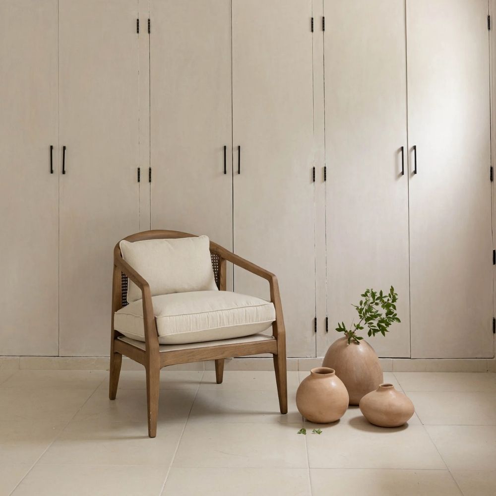 Contemporary accent chair with light boucle cushions and natural wood frame featuring open cane sides.