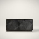 Black wooden sideboard with dramatic concentric carved patterns across its double-door front.