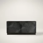 Black wooden sideboard with dramatic concentric carved patterns across its double-door front.