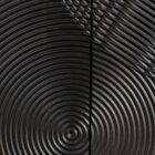 Black wooden sideboard with dramatic concentric carved patterns across its double-door front.