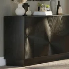 Black wooden sideboard with dramatic concentric carved patterns across its double-door front.