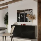 Black wooden sideboard with dramatic concentric carved patterns across its double-door front.