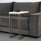 Modern white C-shaped end table with a thin metal base in a bronze finish and a sleek white top.