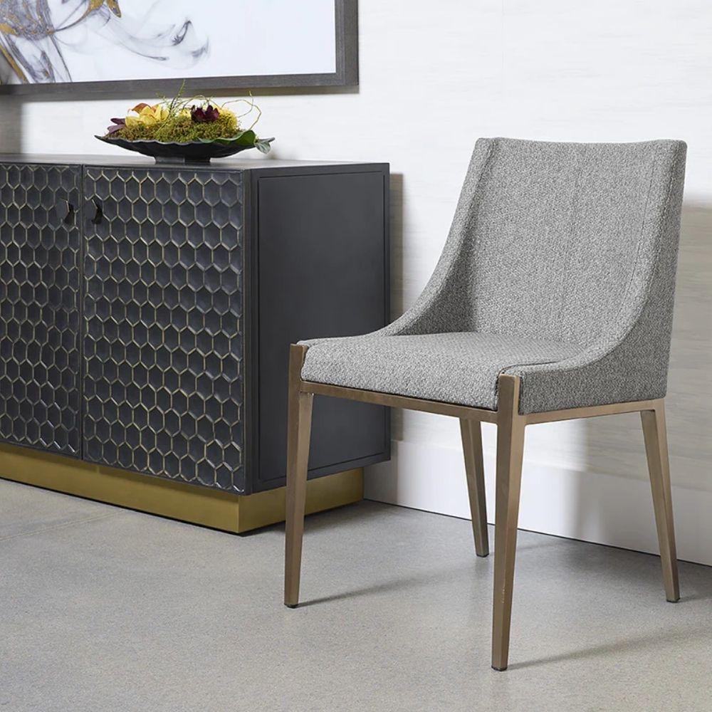 A contemporary dining chair with a curved high backrest and sleek, tailored lines in textured grey upholstery over a taupe wood frame.