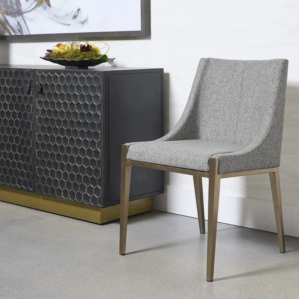 A contemporary dining chair with a curved high backrest and sleek, tailored lines in textured grey upholstery over a taupe wood frame.